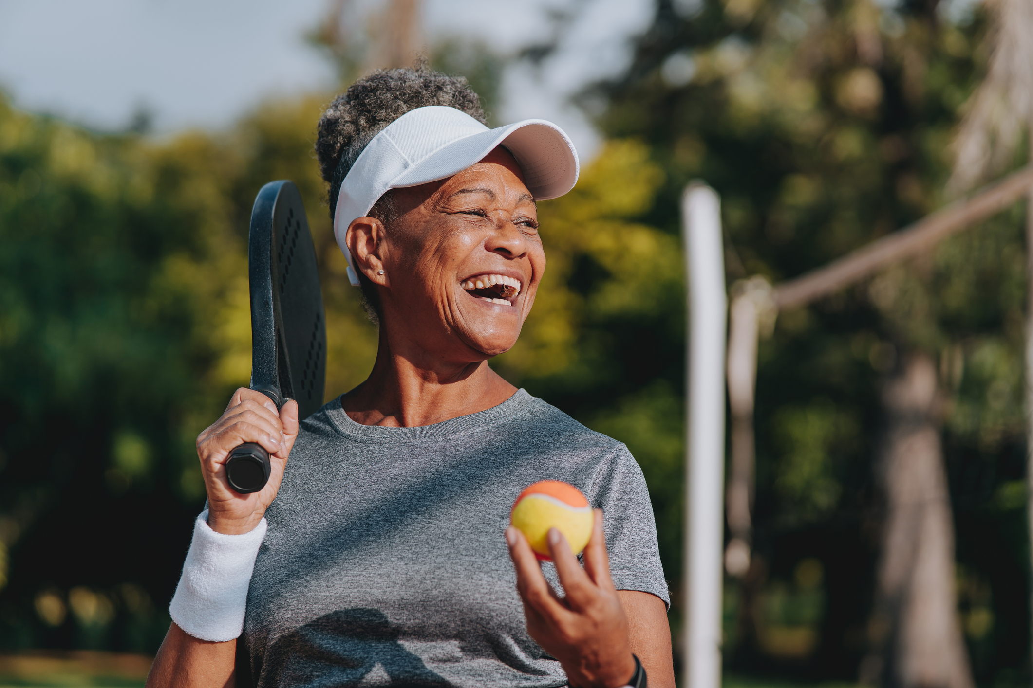 Portrait of a senior woman playing beach tennis
